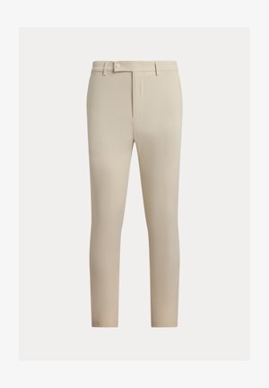 Bézs színű nadrág sima anyagból, egyenes elülső résszel, övbújtatókkal és egy gombos rögzítéssel. Vékony szabású, egyenes szárú.