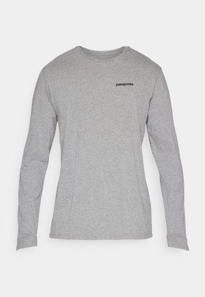 Gray long-sleeve t-shirt made of cotton blend fabric, featuring a crew neck and small black logo print on the left chest.
