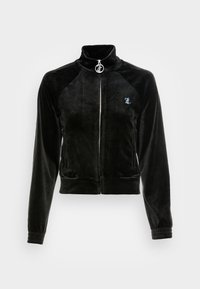 Black velour zip-up jacket with a high collar, ribbed cuffs, and a silver logo accent on the chest. Features a sleek, fitted design.