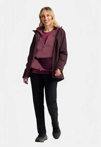 Maroon waterproof jacket, light purple fleece, and black pants. Features a zippered front, adjustable cuffs, and a waist pouch. Casual outdoor attire.