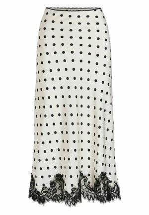 Jupe à pois crème avec des pois noirs, dotée d'un ourlet en dentelle noire festonné. Tissu lisse, coupe ajustée, longueur au genou.