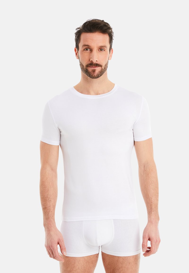 White fitted t-shirt with short sleeves, round neckline, smooth texture, worn with matching white boxer shorts, plain design, minimal details.