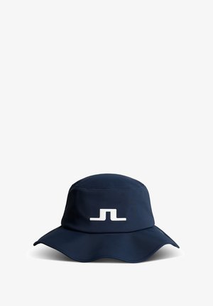 Navyblauer Bucket Hat aus weichem Material, mit breitem, geschwungenem Rand und einem auffälligen weißen Logo auf der Vorderseite.