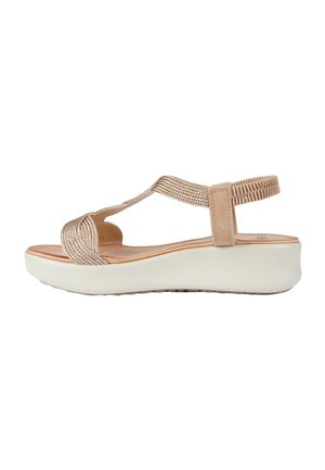 Sandalo beige da donna con cinturini intrecciati, cinturino posteriore elastico, sottopiede imbottito e suola platform bianca.