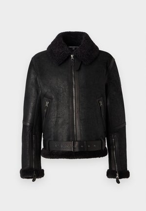 Black leather jacket with a textured finish, shearling collar, zip closure, and belted waist. Features zippered pockets and soft cuffs.