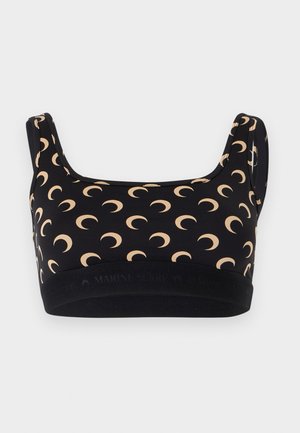 Sutien sport negru cu modele bej sub formă de semilună și bretele late, prevăzut cu o bandă elastică neagră în partea de jos.