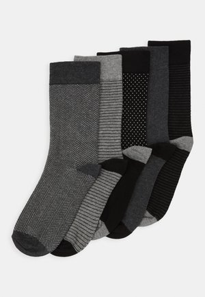 Five pairs of socks in shades of gray and black, featuring herringbone, striped, and dotted patterns with contrasting cuffs.