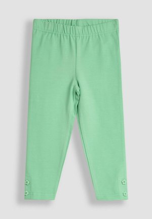 Leggings verde menta hechos de una tela suave y elástica. Presentan una cinturilla elástica y dos botones decorativos en el dobladillo.