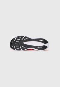 Black and white athletic shoe sole with a textured pattern. Curved shape with horizontal and vertical grooves for traction.