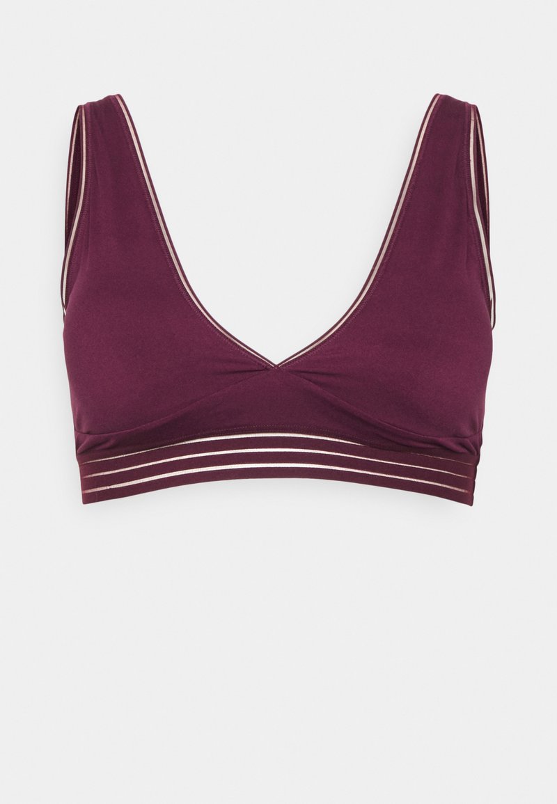 Møtt bralette med dyp V-utringning, brede stropper og en kant med tre horisontale sølvstriper. Glatt tekstur.