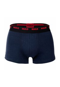 Navy blue boxer briefs made of soft fabric, featuring a black waistband with red "Hugo" branding and a contoured pouch design.
