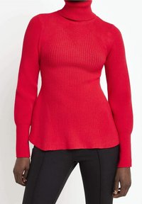 Červený žebrovaný rolák s dlouhými rukávy, který má přiléhavý střih a mírně rozšířený spodní lem. Vyroben z texturované pleteniny.