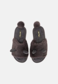 Gray fluffy slippers with pom-poms and ear-like accents, featuring a soft texture and a flat sole. Ideal for indoor use.