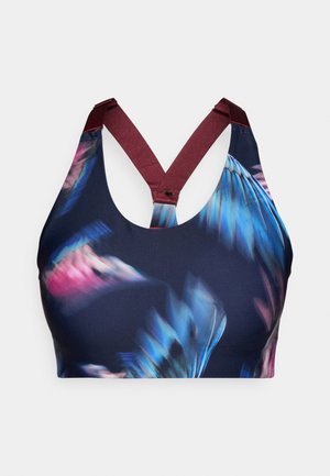 Sportovní podprsenka v námořnické modři s barevným květinovým vzorem; má křížové ramínka v burgundské barvě. Vyrobena z hladké, elastické látky pro maximální komfort.