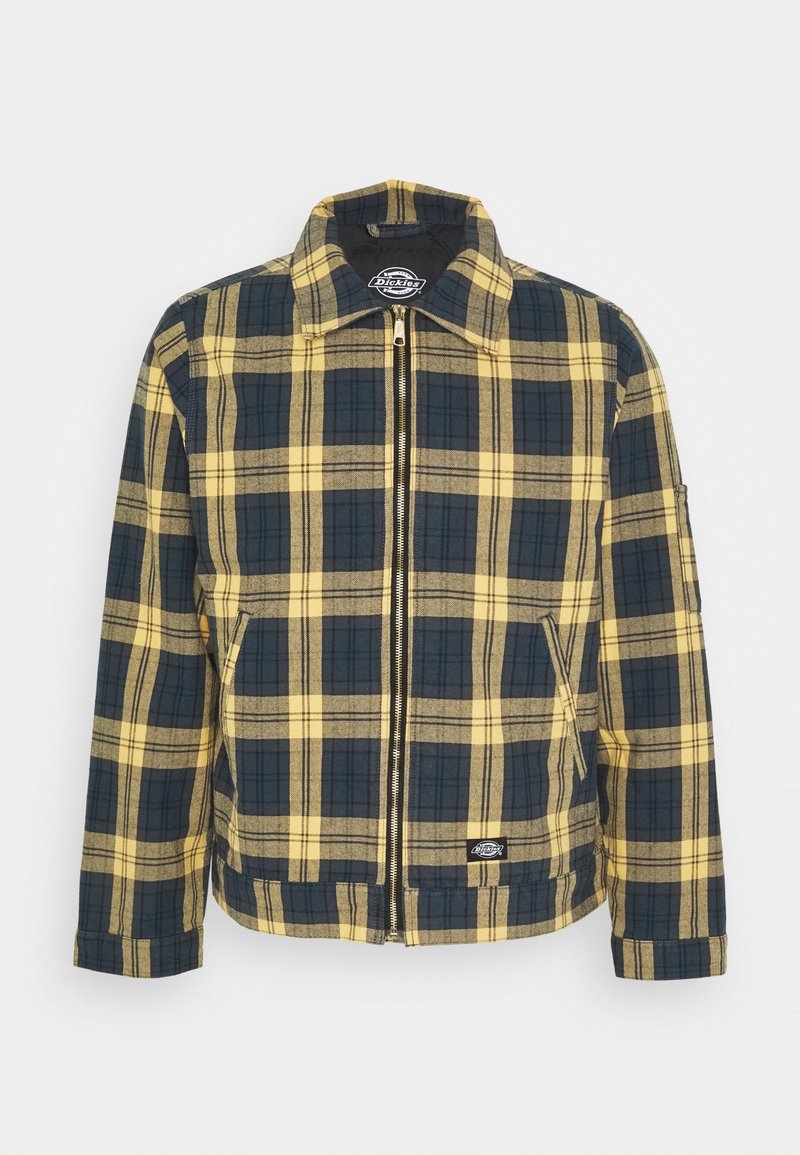Kostkovaná bunda v žluté a tmavě modré barvě, se zapínáním na zip vpředu, špičatým límečkem a bočními kapsami. Vyrobená z texturované látky.
