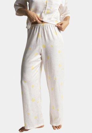 Pantalons de pyjama pour femmes en tissu léger avec une base blanche et un motif floral jaune. Comprend une taille élastique et une coupe droite.