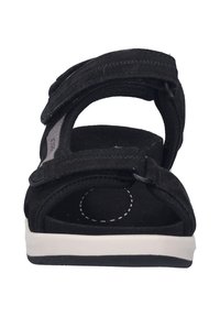 Czarne zamszowe sandały z dwiema regulowanymi paskami na rzep, wyściełaną wkładką oraz białą gumową podeszwą. Okrągły wzór kropek na wkładce.
