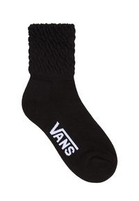 Svart strumpa med ribbad topp, med en slät textur och vit "VANS"-logotyp. Designen är ankellång och ger en åtsittande passform.