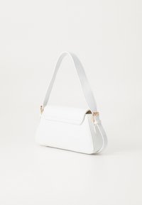 White faux leather handbag with a structured shape, adjustable shoulder strap, and gold-tone hardware accents. Smooth texture and minimalist design.