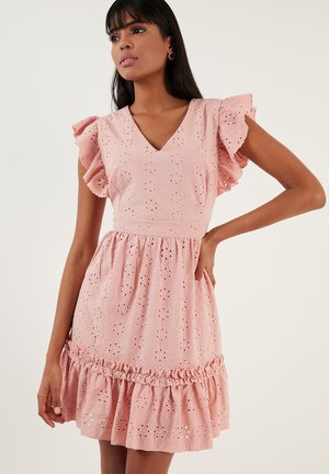 Pink dress with ruffled sleeves, V-neck, embroidered floral pattern, and gathered hem. Made of textured fabric with cut-out details.