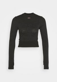 Svart långärmad åtsittande topp i texturerat tyg, med hög halsringning, kort längd och tumhål i ärmarna.