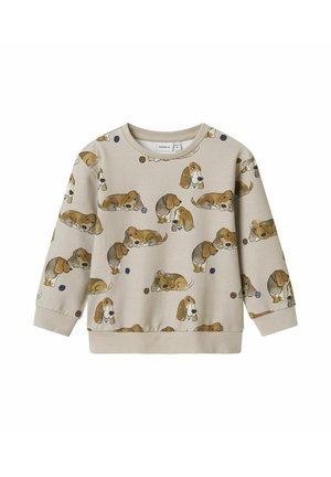 Sweatshirt beige clair à manches longues, arbore un imprimé répétitif de chiens de style cartoon et des motifs circulaires en bleu et marron.