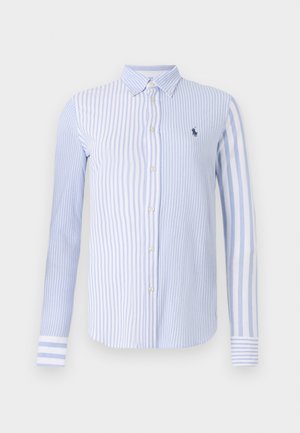 Ribadestatud helesinine ja valge nööbiga särk. Omab kraega kaela, pikki varrukaid ja väikest broderi logo rinnal.