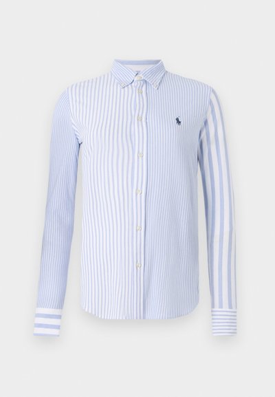 Ribadestatud helesinine ja valge nööbiga särk. Omab kraega kaela, pikki varrukaid ja väikest broderi logo rinnal.