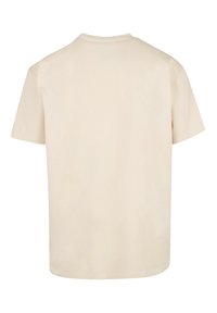 Short-sleeve, beige t-shirt made of cotton with a relaxed fit. Features a round neckline and a smooth texture. No visible logos or designs.