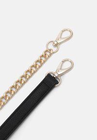 Gold chain strap and black leather strap ends with silver lobster clasps on a white background, both engraved with "VALENTINO".