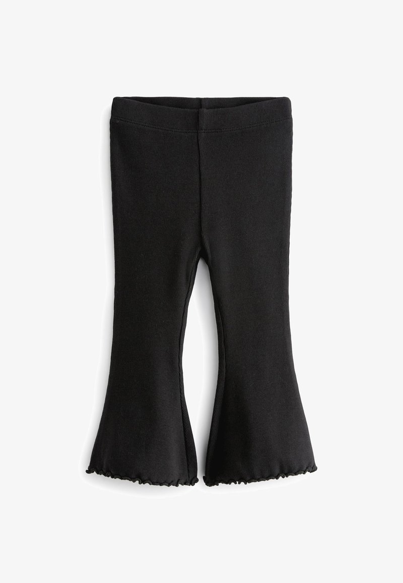 Leggings negros con relieve y dobladillos acampanados, confeccionados con un material elástico y bordes rizados en la parte inferior. Textura suave y diseño ajustado.