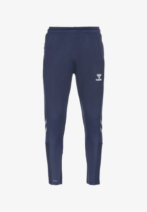 Marineblauwe taps toelopende sportbroek met elastische taille, reflecterende chevronstrepen aan de zijkanten en wit hummel-logo op het bovenbeen.