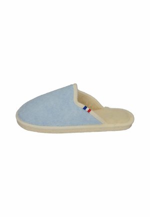 Blue wool slippers with a soft beige lining, rounded shape, and cream-colored sole. Features a small red, white, and blue striped accent.