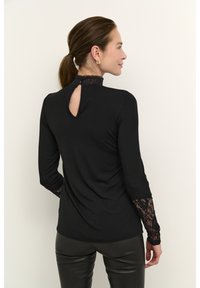 Black long-sleeve top featuring a high lace neckline, lace details on sleeves, and a keyhole opening at the back. Smooth fabric texture.