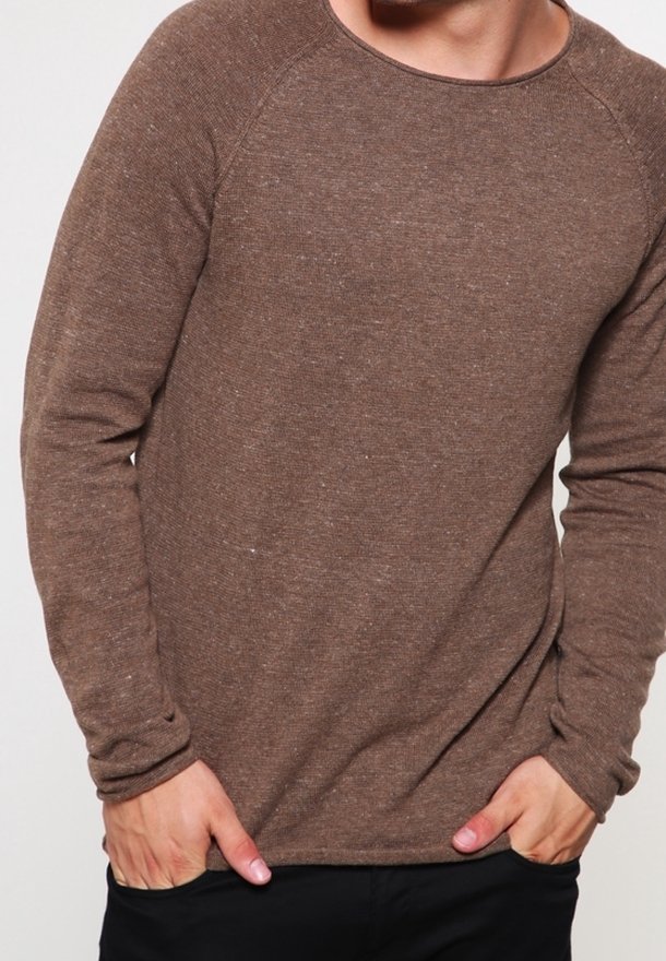 Brown long-sleeve shirt with a textured knit, round neckline, and raglan sleeves, paired with black pants.