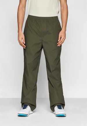 Olive green, lightweight, elastic waistband trousers with a relaxed fit; features straight legs and soft texture. Worn with white and blue shoes.