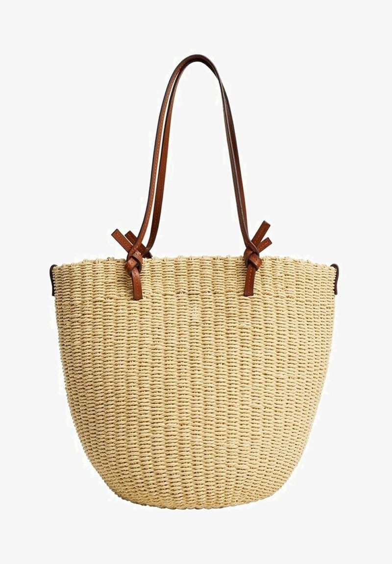 Sac en paille tressée de couleur naturelle avec des poignées en cuir marron, présentant une forme arrondie et une surface texturée.