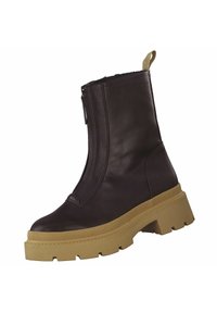 Bottine en cuir brun avec une fermeture éclair sur le côté et une semelle épaisse beige. Elle possède une tirette à l'arrière et une semelle extérieure en caoutchouc texturé pour l'adhérence.