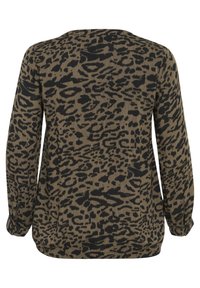 Langärmeliges Oberteil aus einem beige Stoff mit einem schwarzen Leopardenmuster. Der Rundhalsausschnitt und die eng anliegenden Bündchen betonen die Silhouette.