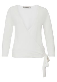 Top cruzado blanco fabricado en suave tejido de punto, con mangas largas, escote en V profundo y un detalle atado en el costado con un diseño simple y limpio.