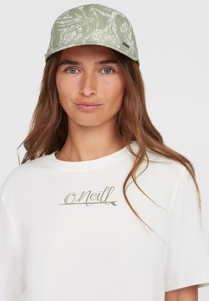 Light green cap with a textured pattern; features a curved brim and a tag on the side. Worn with a white T-shirt displaying a logo.