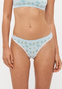 Light blue floral-patterned underwear made of soft fabric. Features delicate lace trim along the waistband and leg openings.