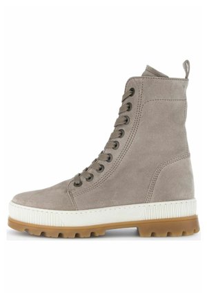 Bota alta de ante gris con una entresuela de goma blanca y suela externa de color marrón texturizada; presenta ojales de metal y una pestaña en la parte trasera.