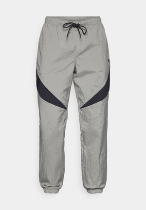 Lightweight, grey windbreaker pants with black diagonal accents, elastic waistband, and cuffs. Textured fabric with a smooth finish.