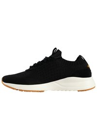 Black athletic shoe with a knitted upper, textured pattern, lace-up design, and a white midsole. Features a gum rubber outsole.