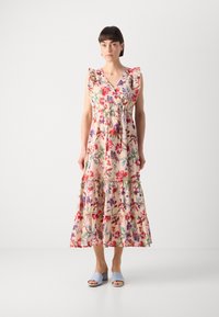 Rochie maxi dintr-un material roz deschis, cu modele florale vibrante. Are mâneci volan, decolteu în formă de V și volane înfășurate la margine.