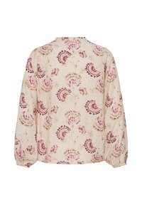 Blouse rose pâle à manches longues avec poignets élastiques, présentant un motif floral en nuances de rose et de bordeaux sur un tissu texturé.