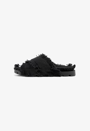 Black slide sandals made of textured fabric with a frayed edge detail, featuring a flat black sole and open-toe design.