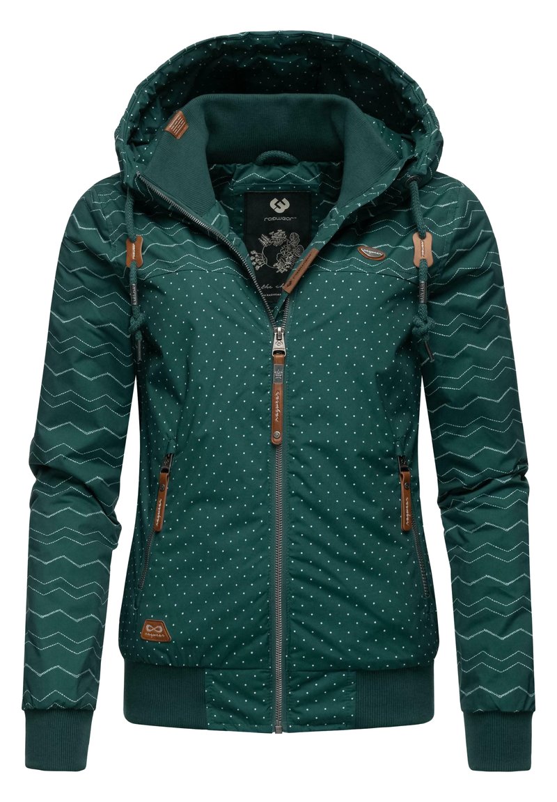 Veste vert foncé avec un motif à pois et en zigzag, présentant une capuche, une fermeture éclair, des accents en cuir marron et des poignets élastiques à l'ourlet.