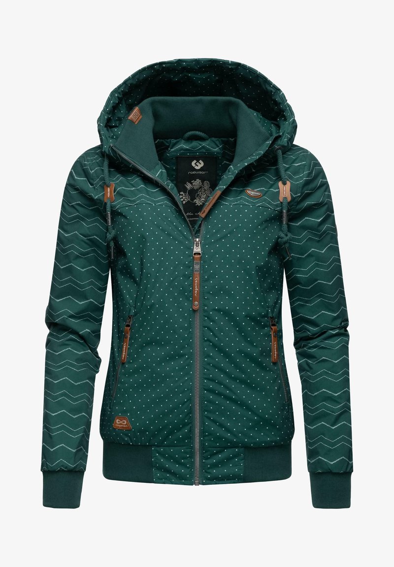 Giacca verde scuro con motivo a pois e zigzag, dotata di cappuccio, chiusura con zip, dettagli in pelle marrone e polsini elastici all'orlo.